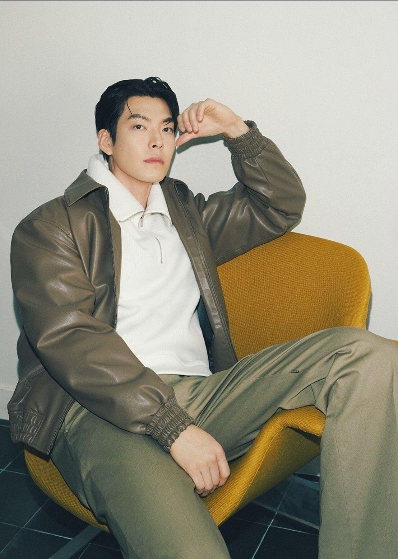 Acing the leather jacket, Kim stuns in this olive green jacket paired with a white shirt underneath. And his cool and laid-back pose makes him look even more dashing.